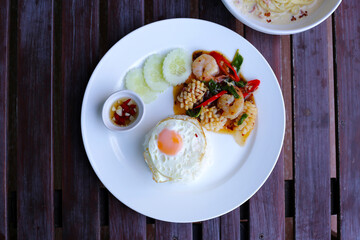 Stir fried squid and shrimp with basil, Rice topped with fried egg