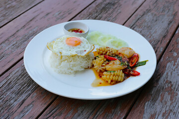 Stir fried squid and shrimp with basil, Rice topped with fried egg