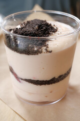 Delicious layered dessert with chocolate and cream served in a cup