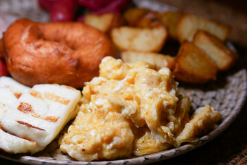 Breakfast spread featuring scrambled eggs, cheese, and pastries