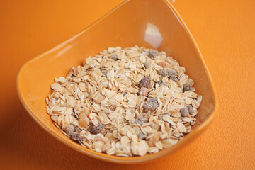 Healthy breakfast bowl filled with oats and dried fruits