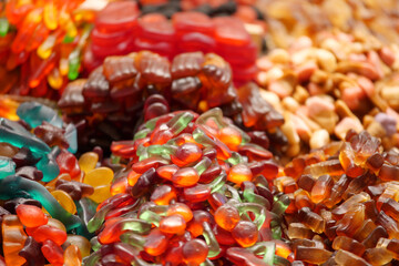 Colorful assortment of gummy candies displayed on a market table