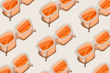 Stylish peach orange sunglasses on beige, minimal trend repeated pattern, sunlight shadow, summer fashion white transparent-framed glasses. Top view of rows of lying eyewear, beach concept