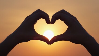 Fototapeta premium Hands Forming a Heart at Sunset: Silhouette of hands shaped into a heart against a warm, golden sunset, symbolizing love, romance, and affection