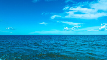 Nature of the beach and sea Summer with sunshine, sandy beaches, clear blue waters sparkling against the blue sky. On an island with good ecology and environment Background for summer vacation