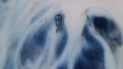 Acrylic overflow. Wave paint. Light stream with dark spots gold glitter. Emergence of contrasting dye clots washing surface with enamel variable deformation texture.