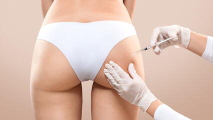 Sculptra butt lifting concept. Slim woman having hip injection at beauty salon, closeup. Plastic...