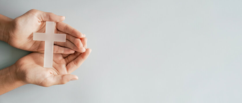 Hands holding white cross, Easter worship, thanks giving, prayer concept
