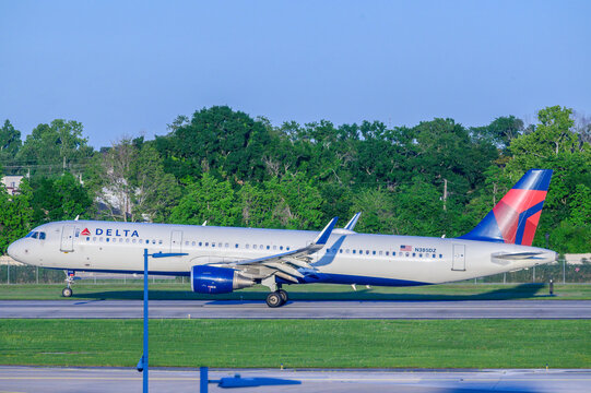 New Orleans, LA, USA - April 30, 2024: Full Side View of Delta Airlines Jet as the Front Wheel Lifts off the Runway during Take Off at Louis Armstrong International Airport