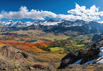 Fototapeta premium Scenic Mountain Landscape with Vibrant Autumn Colors, Majestic Peaks, Clear Blue Sky and Peaceful Lake Setting in Majestic Nature Panorama