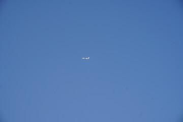 A passenger flight is flying in the clear blue sky