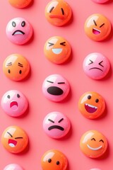 Naklejka premium Colorful round emoticons expressing various emotions arranged in neat rows on a pink background