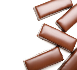 Tasty chocolate covered coconut candies on white background