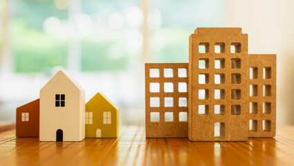 Model wooden house and condo building or company building. Ideas about moving from home to living...