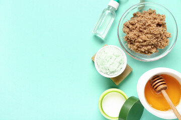 Honey with scrubs, cream and soap on turquoise background. Body massage concept