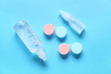 Containers for contact lenses with solutions on blue background