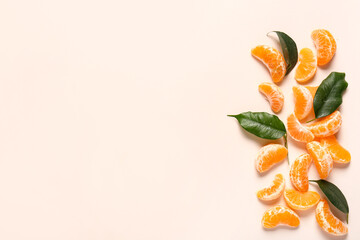 Fototapeta premium Fresh tangerine segments with leaves on pink background