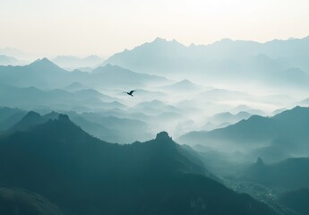 Fototapeta premium Serene Mountain Landscape with Misty Peaks and a Lone Bird in Flight at Dawn in a Tranquil Natural Setting
