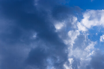 Rain clouds in mid day on blue sky