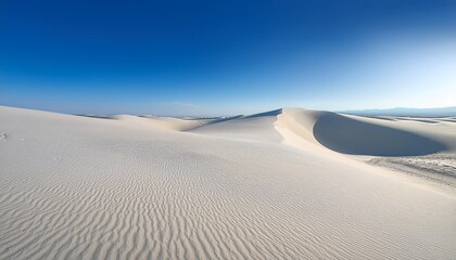 vast expanse of white sand dunes under a clear blue sky