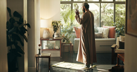 Man, islamic and prayer with faith at house for spiritual worship, praise Allah and belief in Ramadan. Muslim person, praying and dua in salah, forgiveness and mindfulness of fasting tradition of God