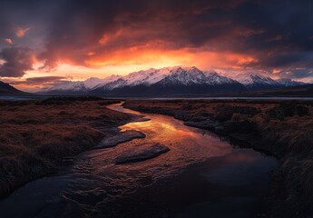Fototapeta premium Serene Sunset Over Snow-Capped Mountains with Flowing River and Dramatic Sky Reflecting Warm Tones