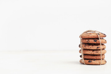 Sweet cookies with chocolate chips on white background