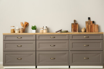 Stylish interior of kitchen with brown counters, groceries and toaster, blurred view