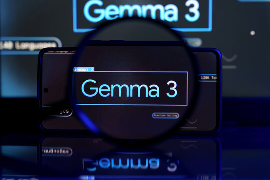 Smartphone screen displaying Google Gemma 3 AI model, with a larger screen in the background. The image emphasizes artificial intelligence and digital technology.