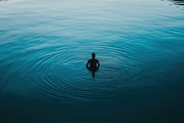A Solitary Figure Meditates In Tranquil Teal Waters, Creating Concentric Ripples Of Peace And Serenity With A Deep, Calming Blue Tone