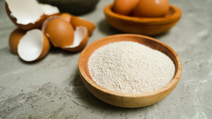 Egg shells that have been ground into calcium flour and placed in a wooden plate