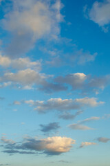Scattered clouds in a blue sky at dusk