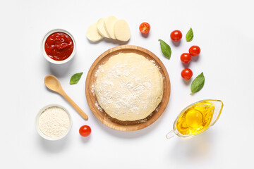 Ingredients for preparing pizza with mozzarella, wooden plate and raw dough on white background