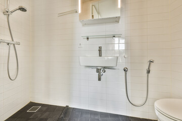 A sleek and contemporary bathroom featuring a walk-in shower with minimalistic fixtures and clean lines, perfect for modern living spaces.