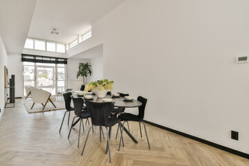 A stylish, modern dining area featuring sleek furniture, natural light, and elegant decor. Perfect for contemporary living spaces and gatherings.