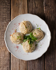 Traditional mantles, dish of the peoples of Central Asia. Manti on a wooden table