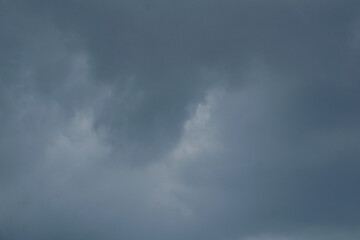 Obraz premium The dark sky with heavy clouds converging and a violent storm before the rain.Bad or moody weather sky and environment. carbon dioxide emissions, greenhouse effect, global warming, climate change.