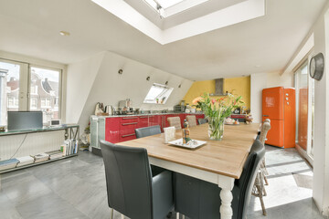 A bright and modern kitchen featuring an open layout, sleek furnishings, and vibrant accents, ideal for cooking and social gatherings. Elegant decor elements enhance its charm.