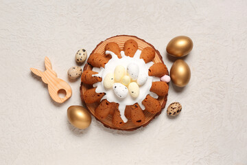Wooden board of sweet Easter bread with eggs on white background