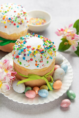 Easter cakes decorated with colorful sprinkles and chocolate eggs on festive table