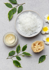 Magnesium flakes, body cream and loofah creating relaxing spa scene