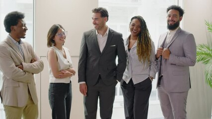 Skilled group of professionals stands confidently in a modern office, highlighting the importance of collaboration and teamwork in creating a thriving workplace culture based on support and respect