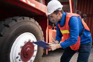 Caucasian man supervisor engineer worker working with truck at container site
