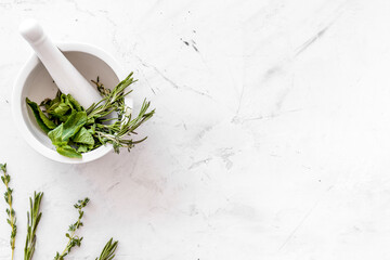 Healing herbs for medicine on white marble background top view m