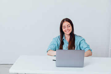 woman working at desk on laptop online learning in office