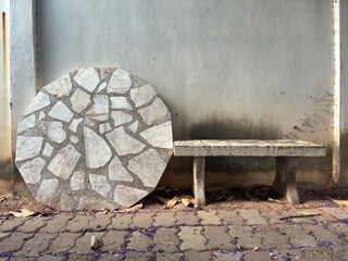The irregular, broken-tile pattern on the slab and the scattered purple petals add a beautiful...