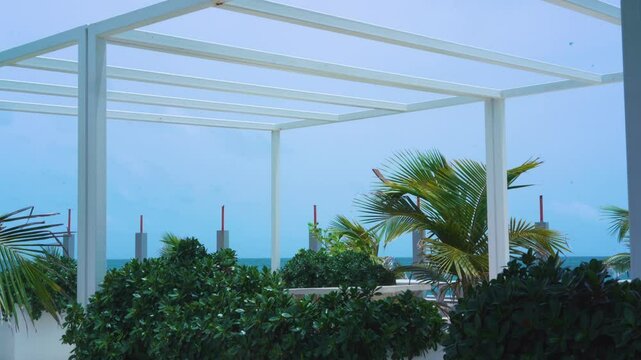 Wind Blowing On Palm Trees Under Pergola Near Condado Beach In San , Puerto Rico. static shot