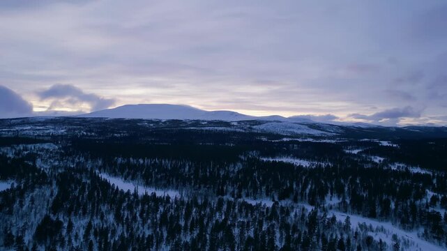 Snowy Forest and Mountain Range in Ringebu, Drone View