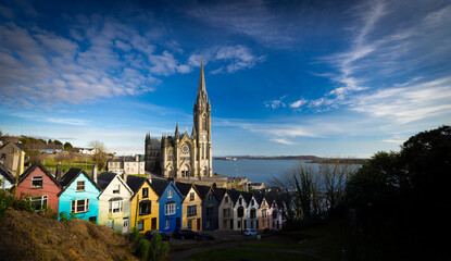 Cobh, Ireland  - March 6th 2025 - Saint Colmans Cathedral and colourful houses on West View