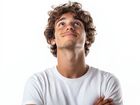 Young man in t-shirt with dreamy cheerful expression thinking looking up isolated on white background